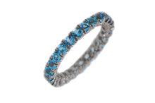 Blue topaz eternity band